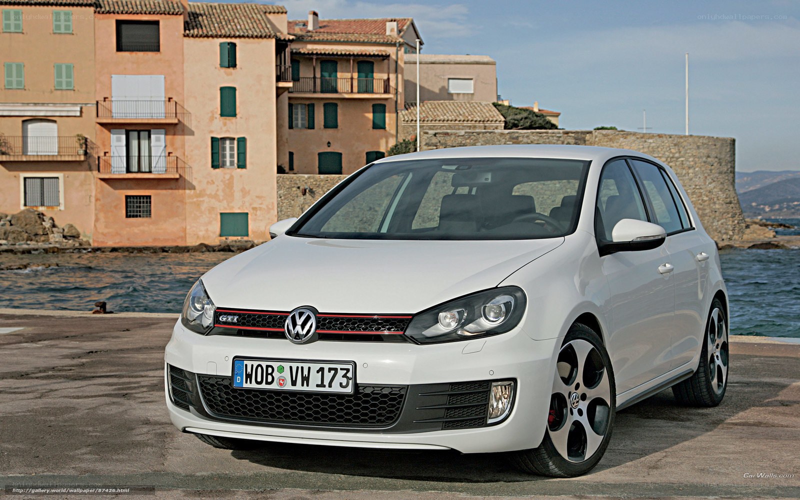 White VW Golf GTI by the sea