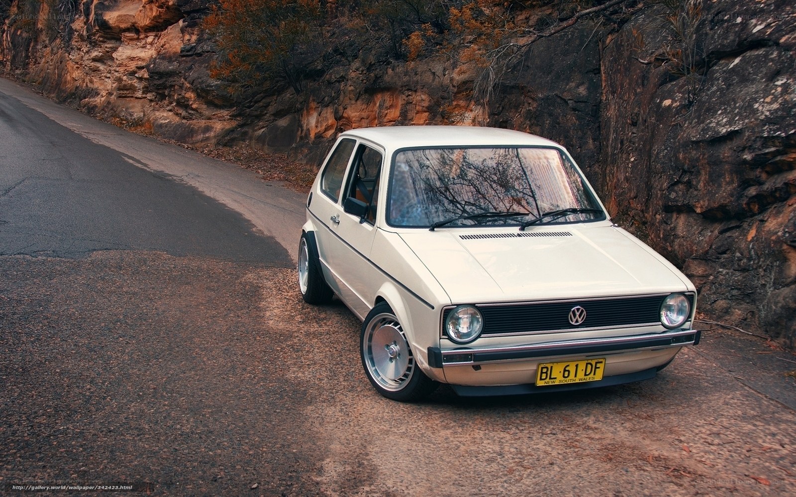 White VW Golf on a winding road