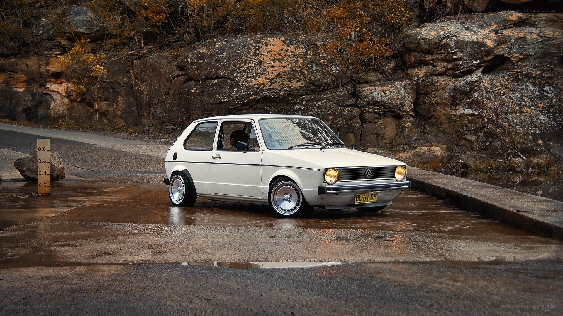 White VW Golf on wet road