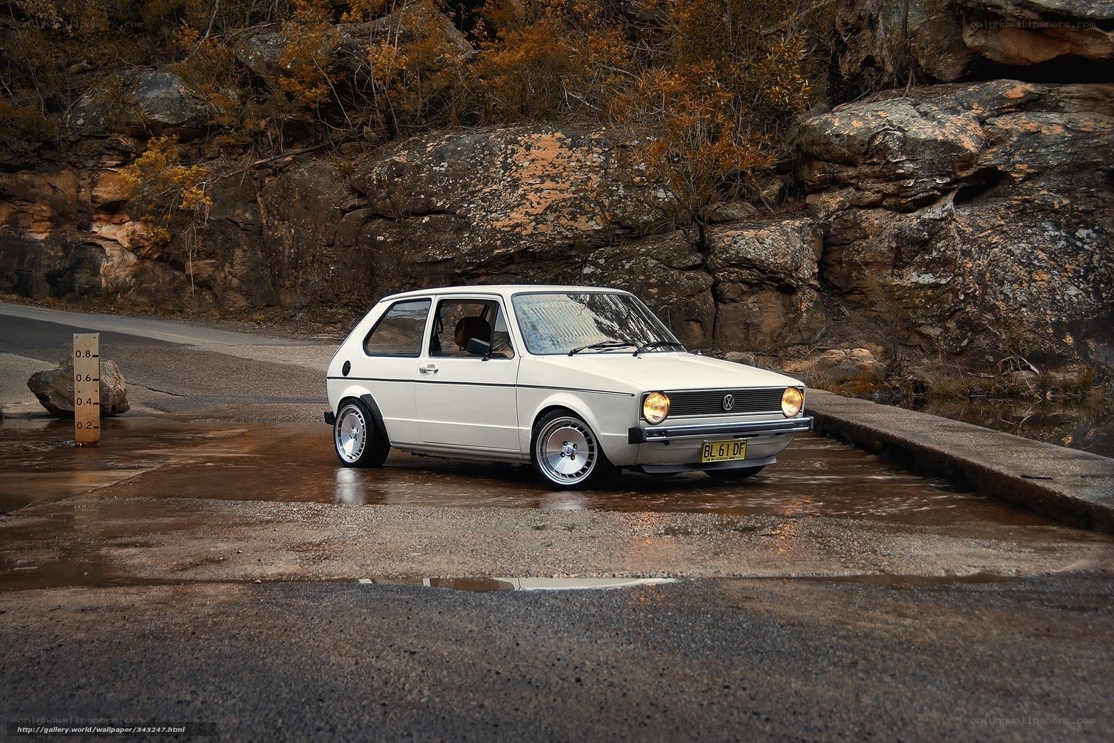 White VW Golf on wet road