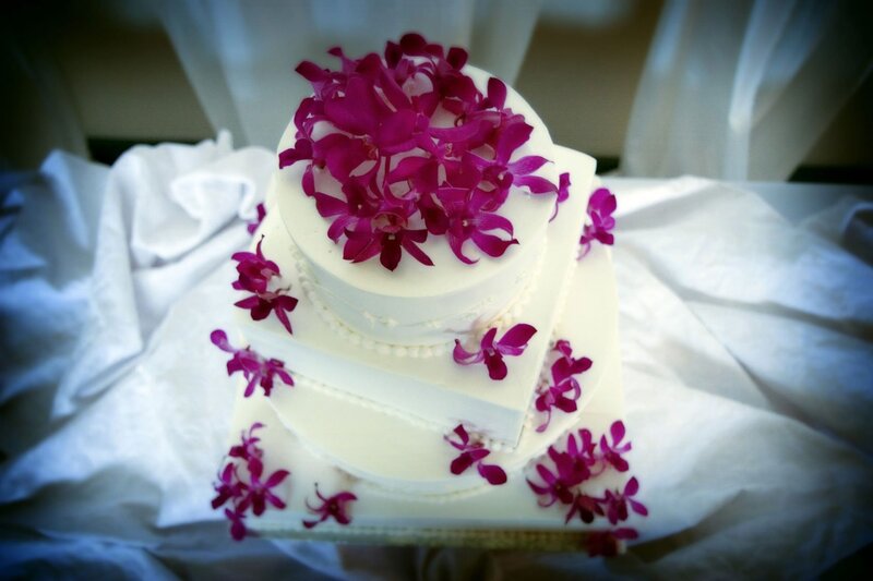 white wedding cake with purple flowers