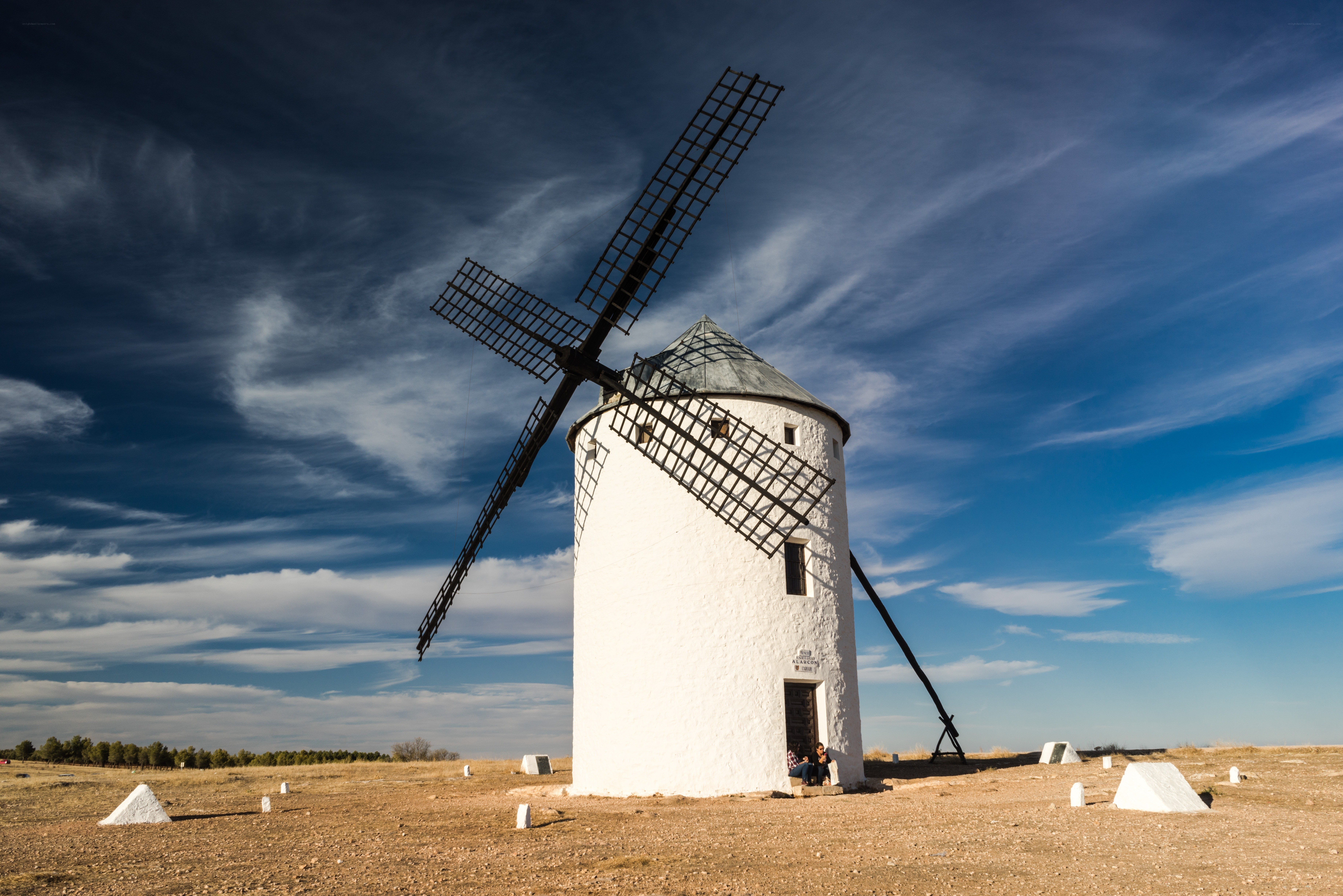 White windmill in a dry field