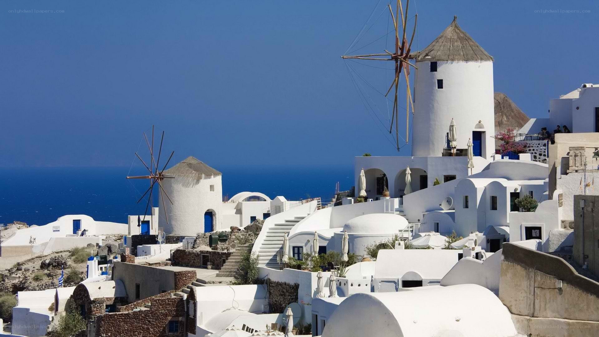 White windmills overlooking the sea
