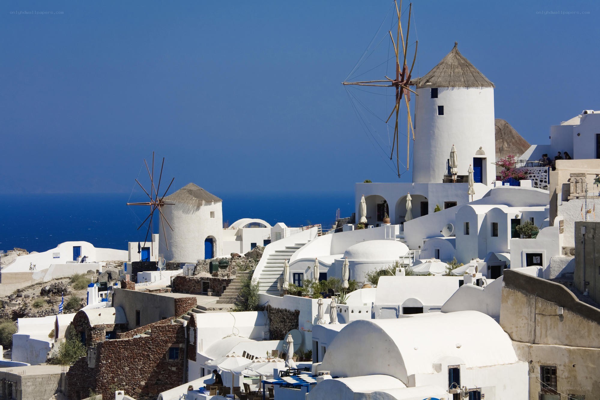 White windmills overlooking the sea
