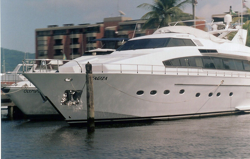 White yacht docked at marina