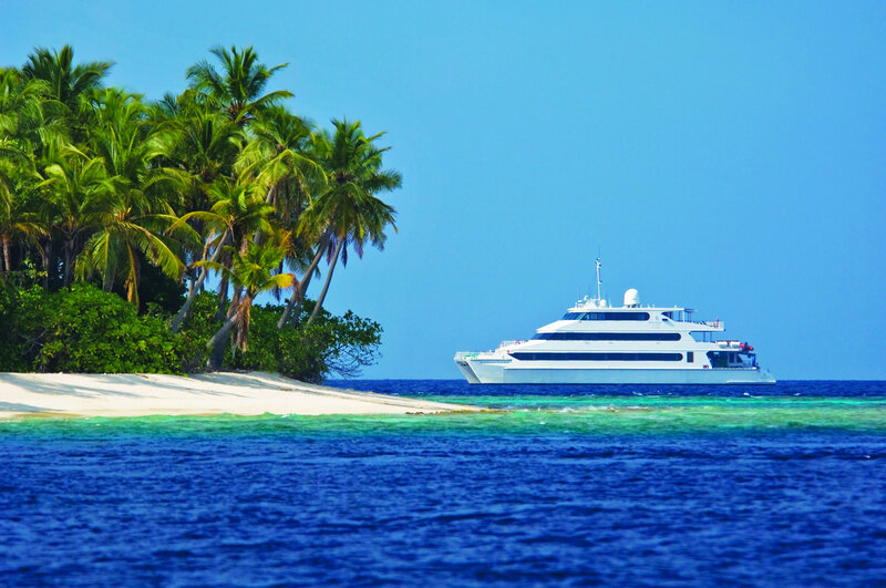 White Yacht Near Island — Blue