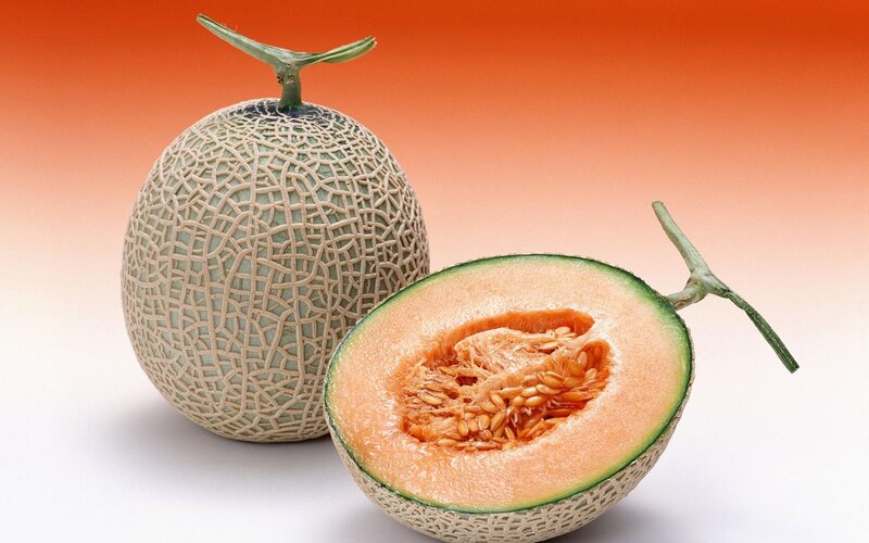 Whole and Halved Cantaloupe — Orange