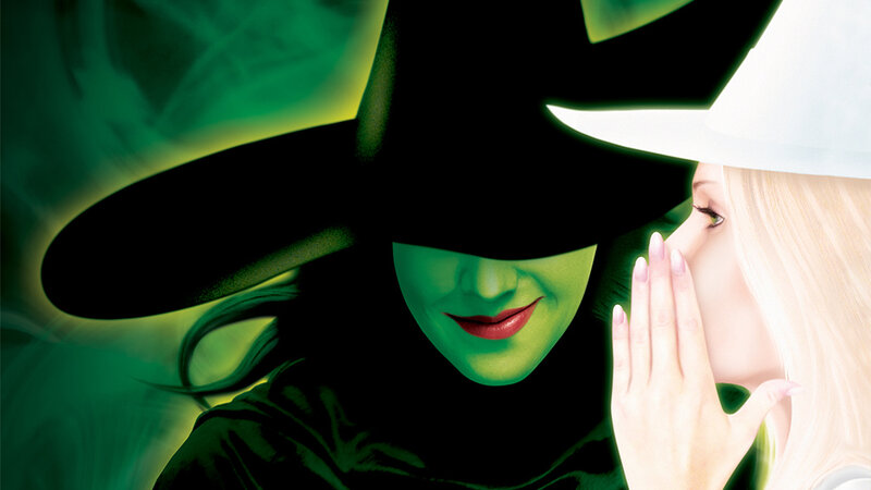Wicked witch whispers to blonde woman