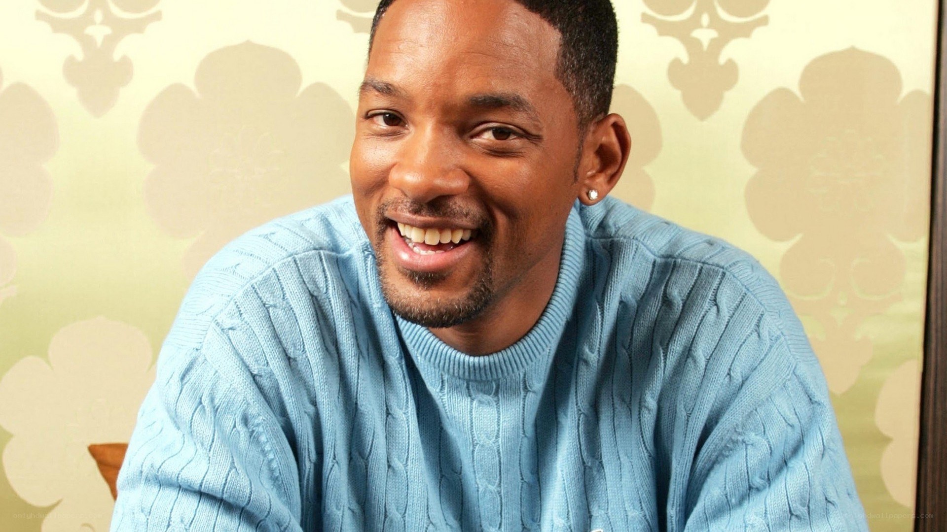 Will Smith smiling in blue sweater
