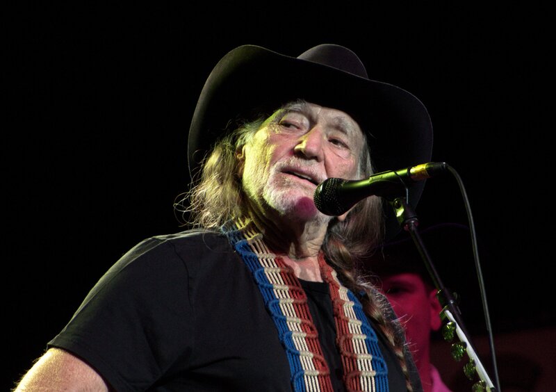 Willie Nelson performing on stage