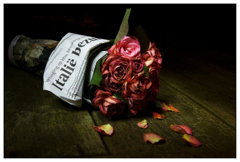 Wilted Roses in Newspaper