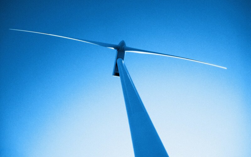 Wind turbine against blue sky