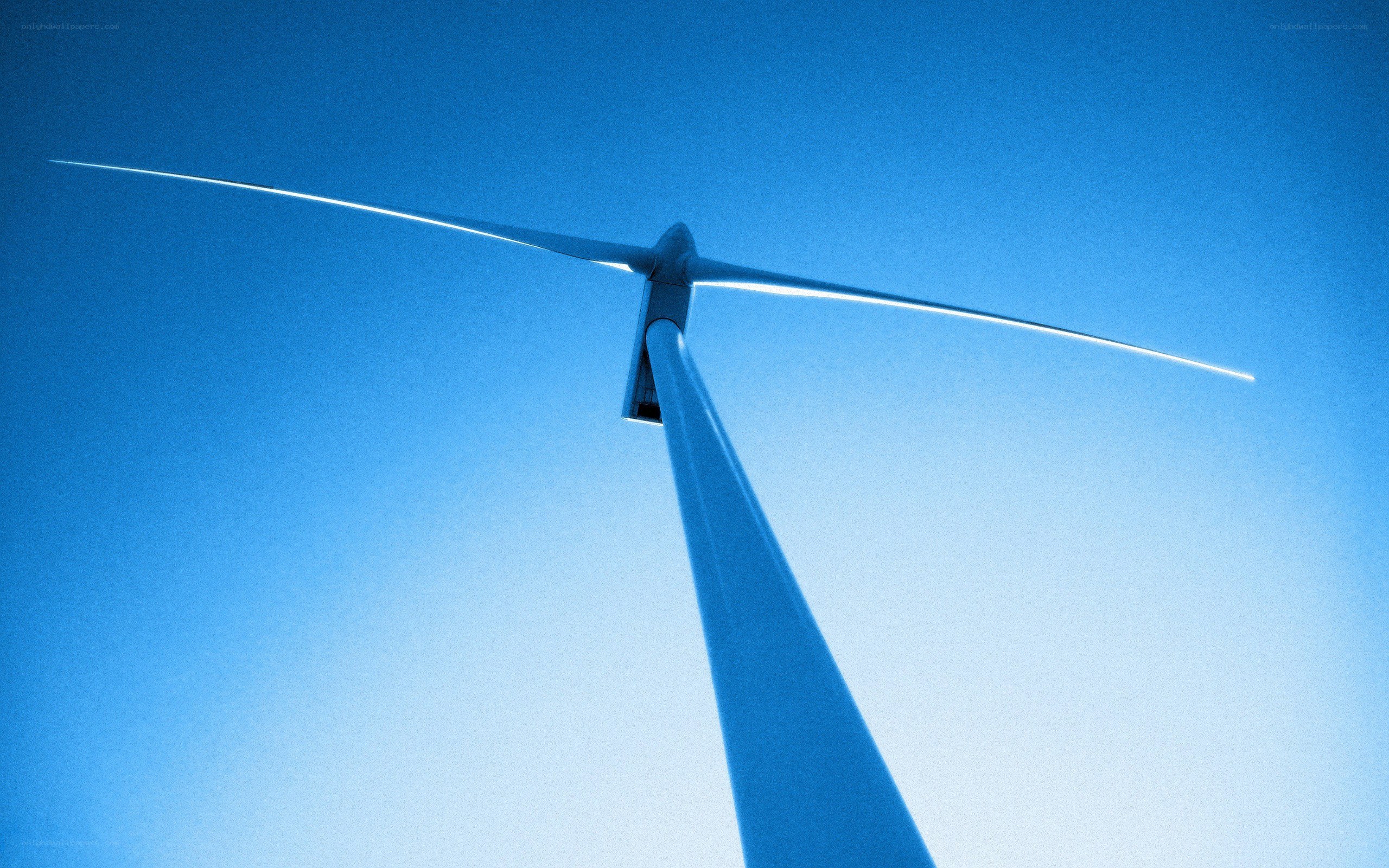 Wind turbine against blue sky
