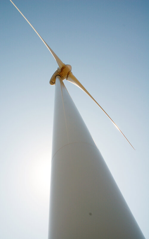 Wind turbine against blue sky