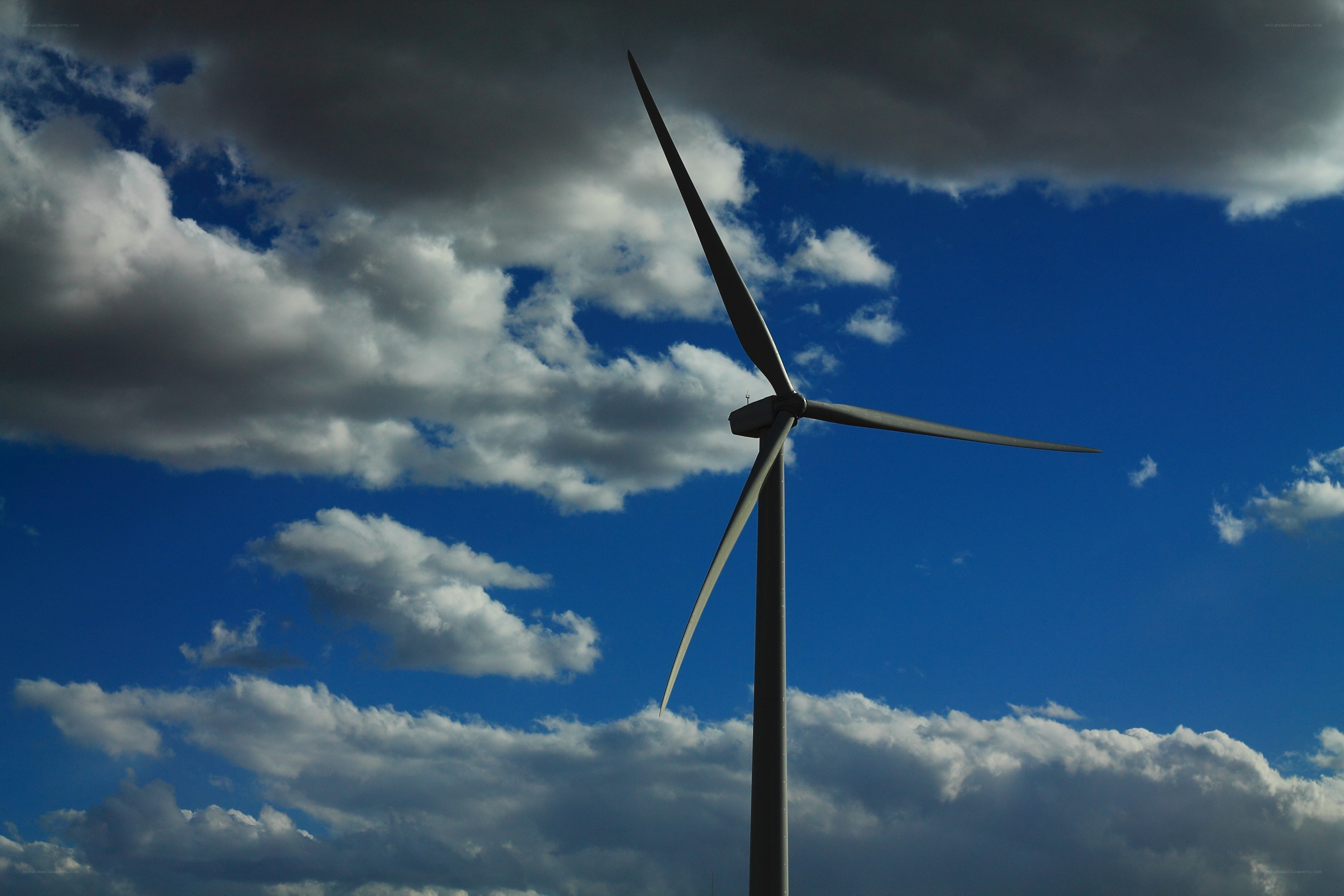 Wind turbine against cloudy sky