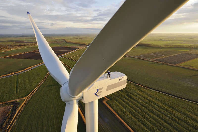 Wind turbine maintenance at sunset