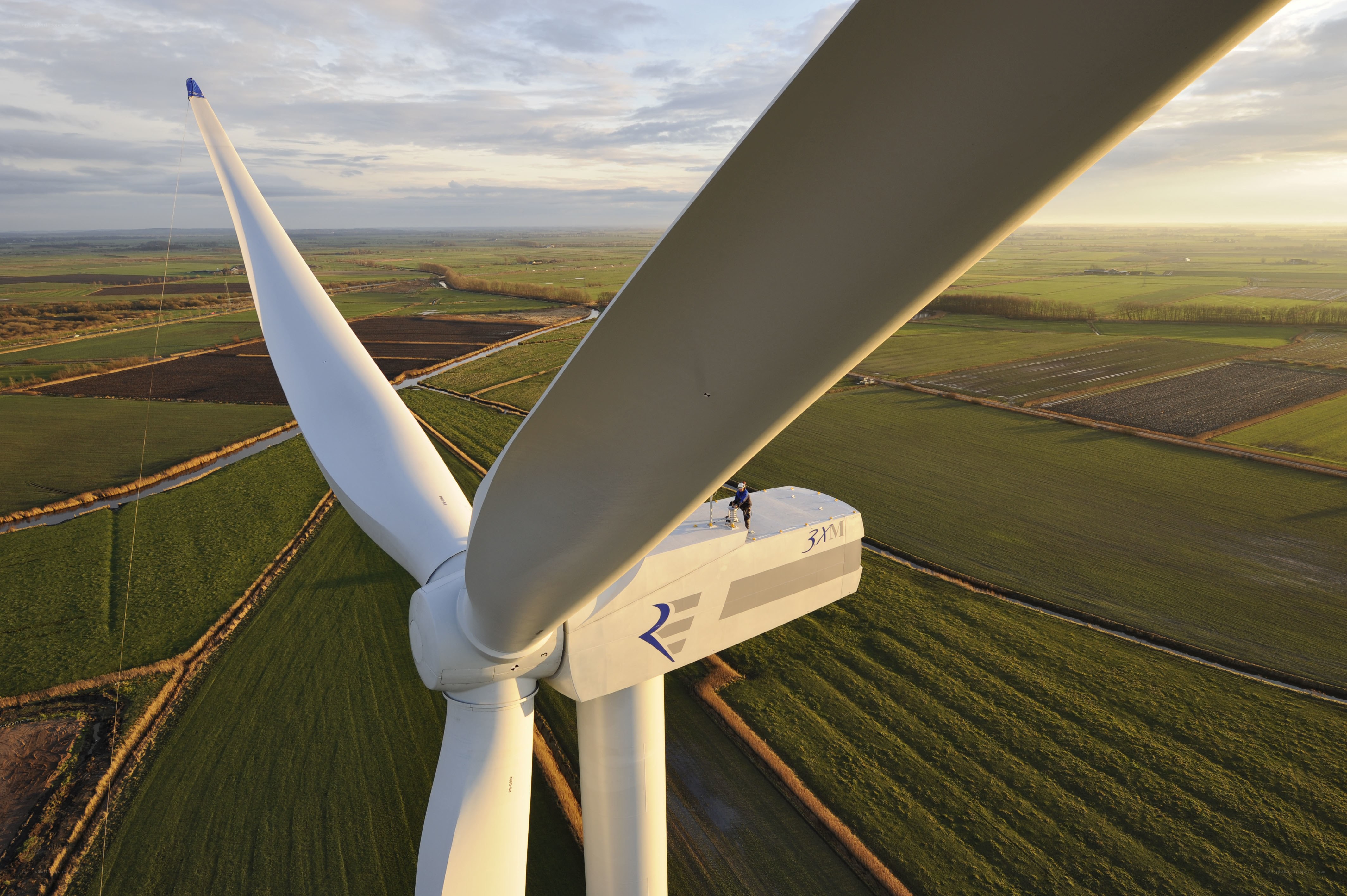 Wind turbine maintenance at sunset