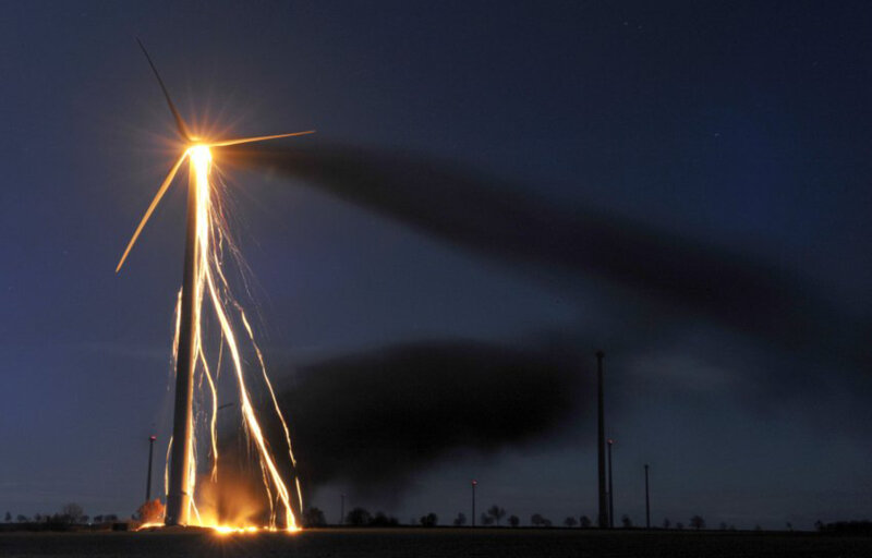 Wind turbine on fire at night