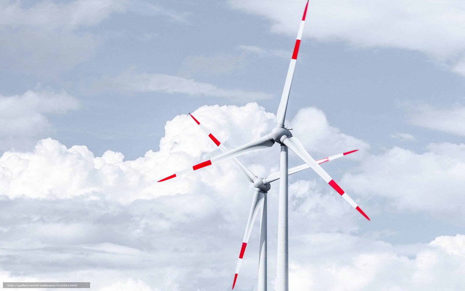 Wind turbines against cloudy sky