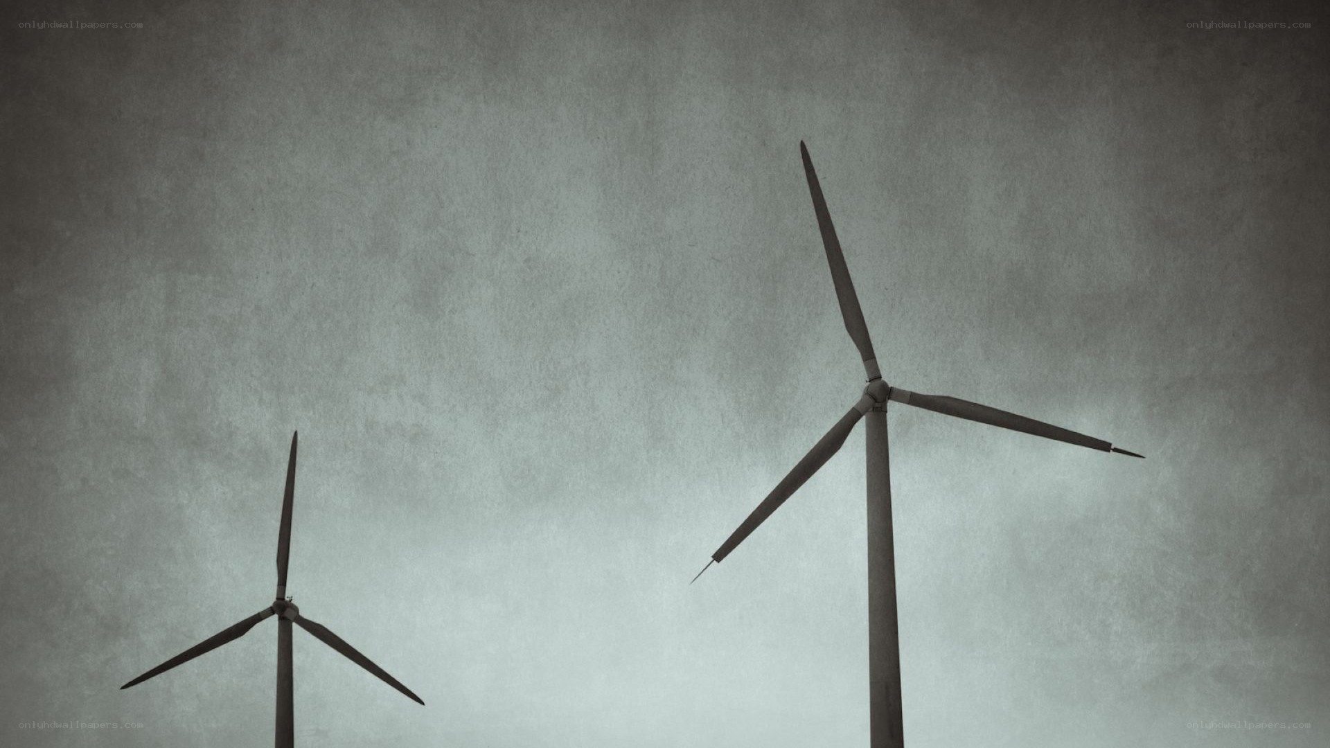 wind turbines against gray sky