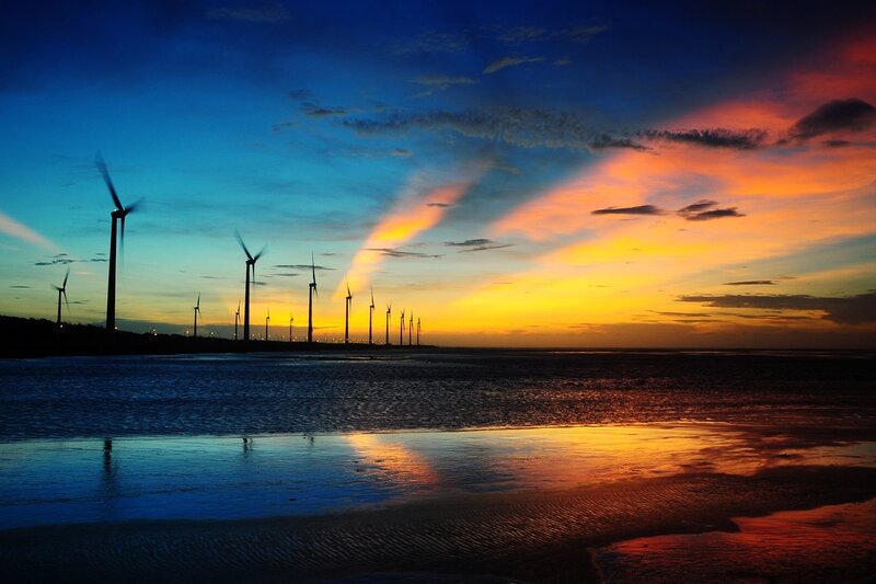 Wind turbines at sunset by the sea