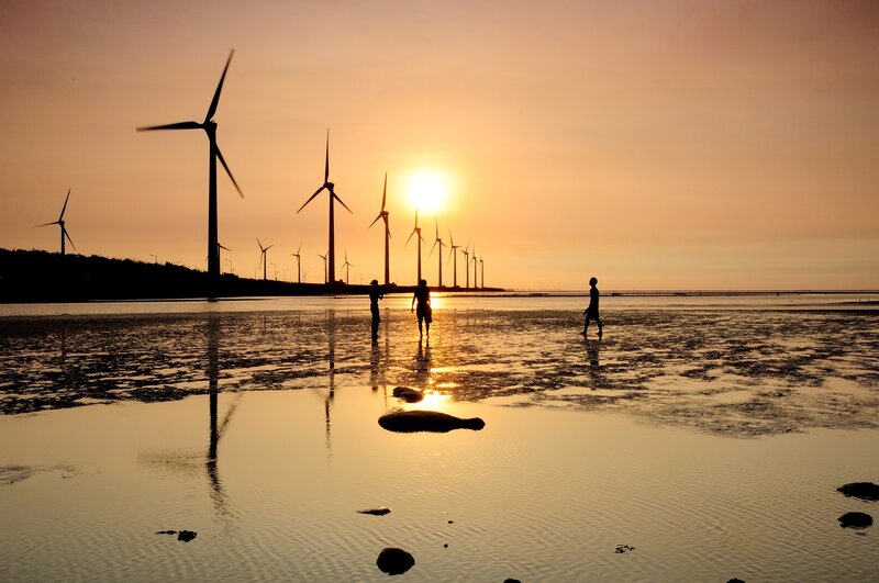 Wind turbines at sunset on beach