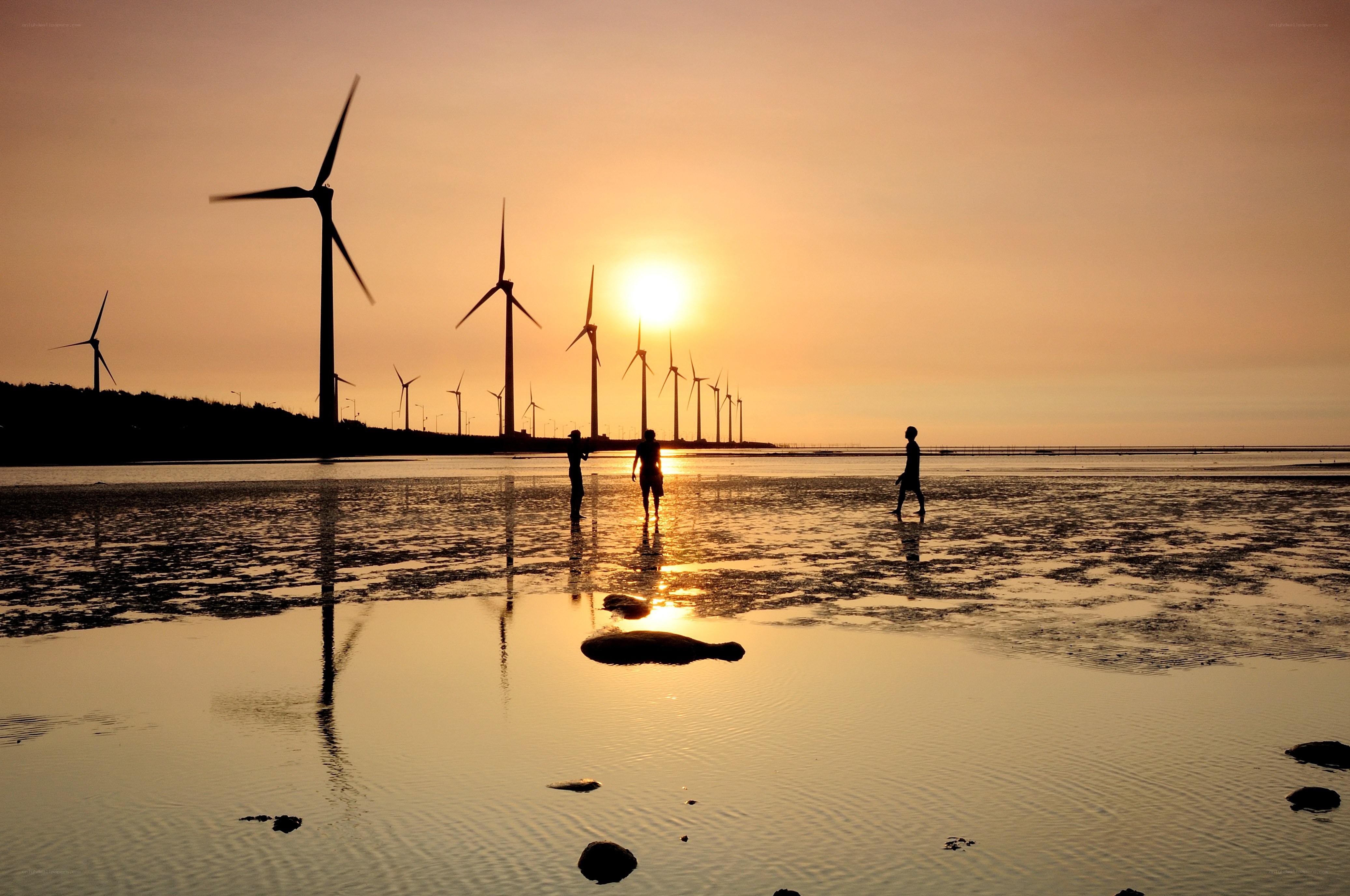 Wind turbines at sunset on beach