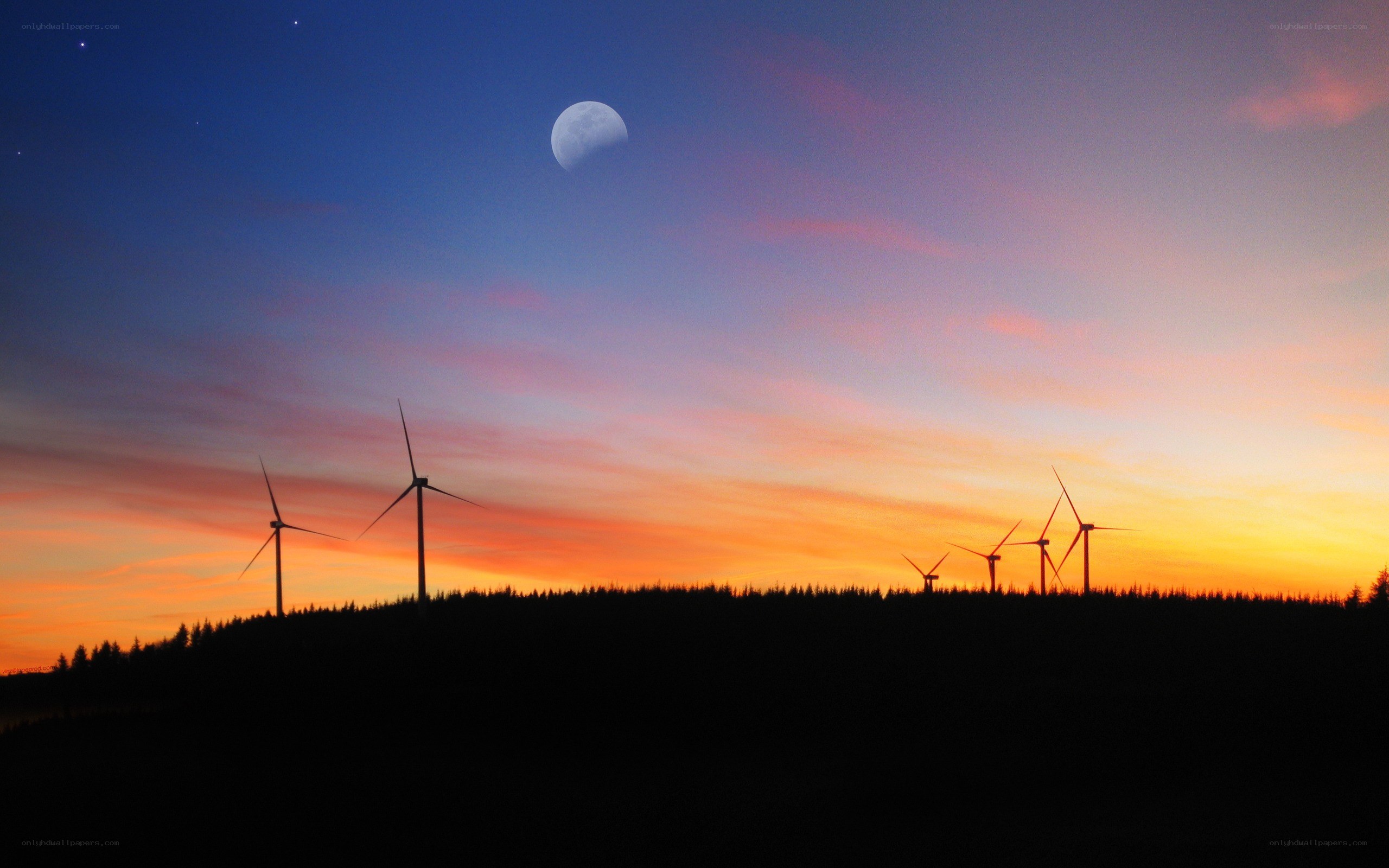 Wind turbines at sunset with moon