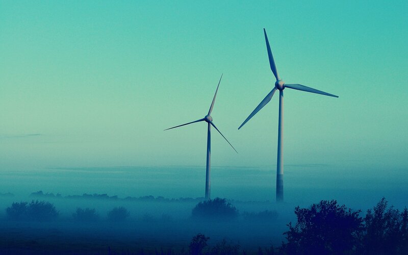 Wind turbines in morning mist