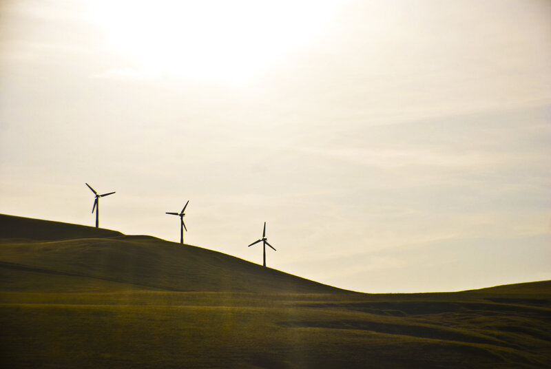 Wind turbines on a hill at sunset