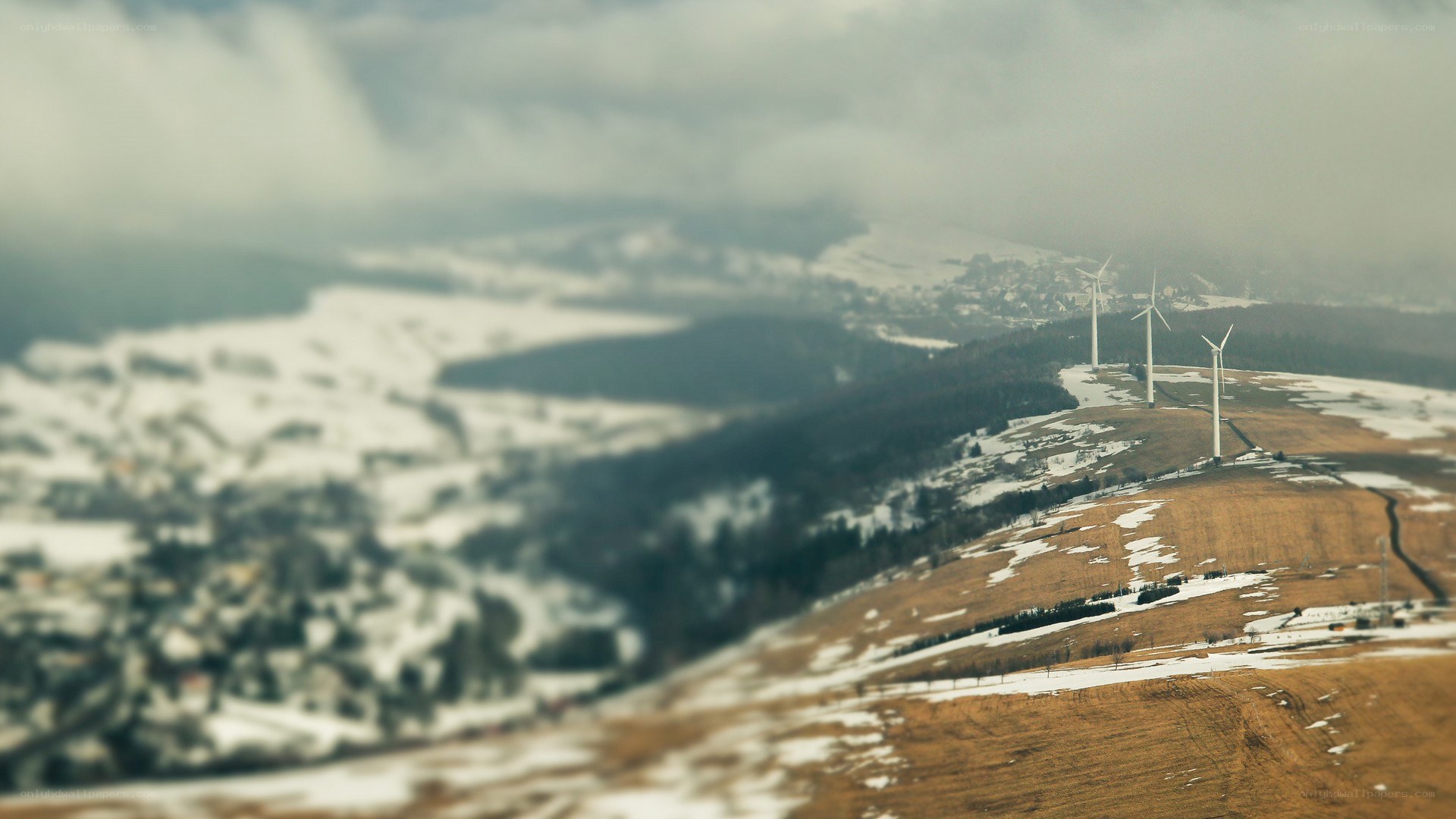 wind turbines on a snowy hill