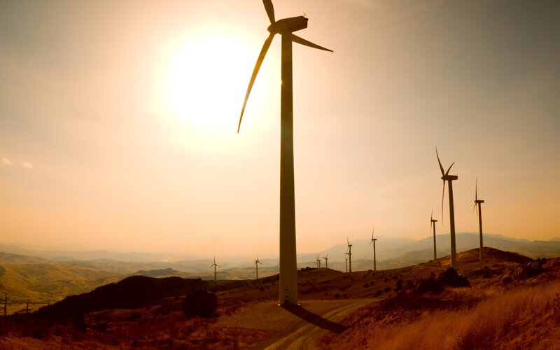 Wind Turbines on Hillside — Orange, Serene, Sunset