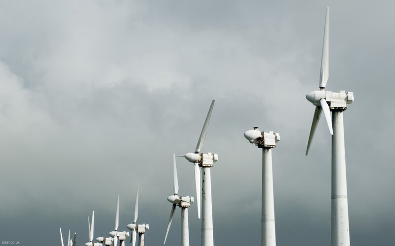 Wind turbines under cloudy sky