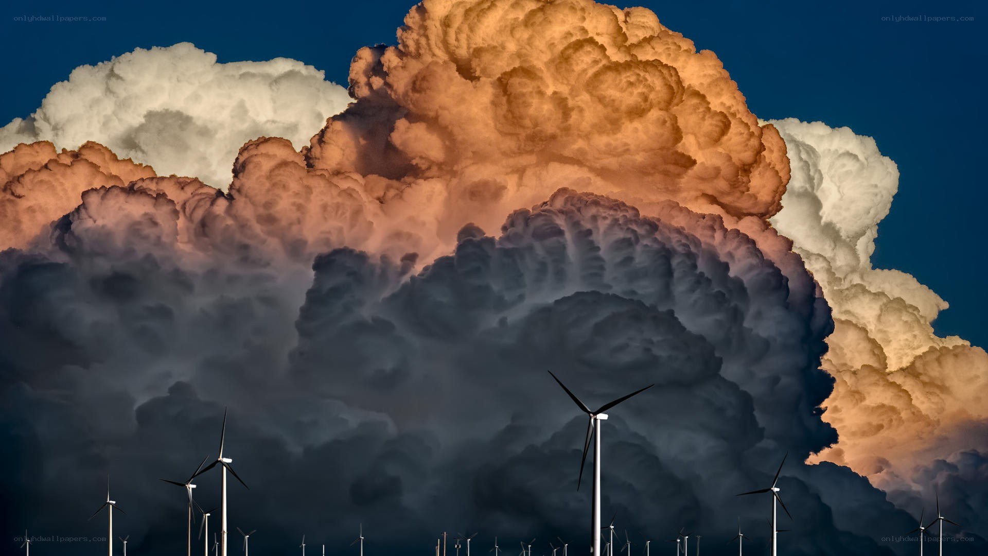 Wind turbines under storm clouds