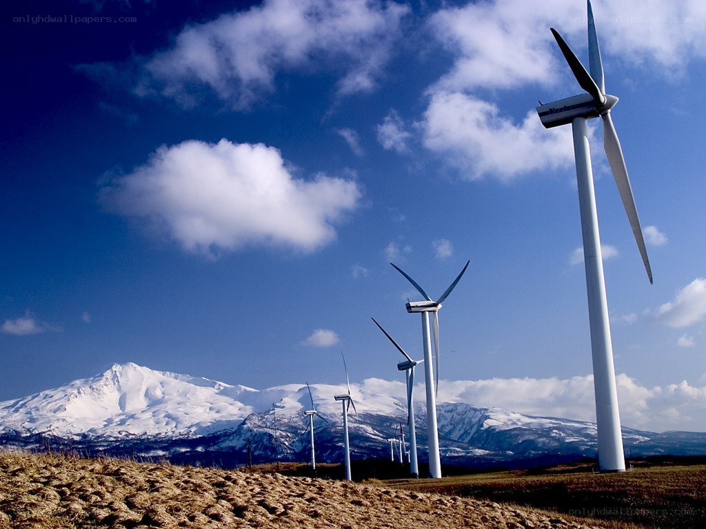 Wind turbines with snow-capped mountains