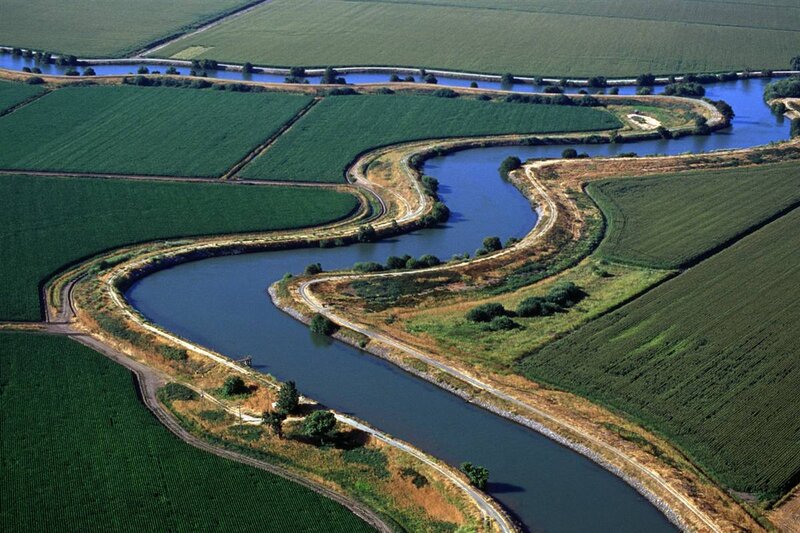Winding Canal Through Fields