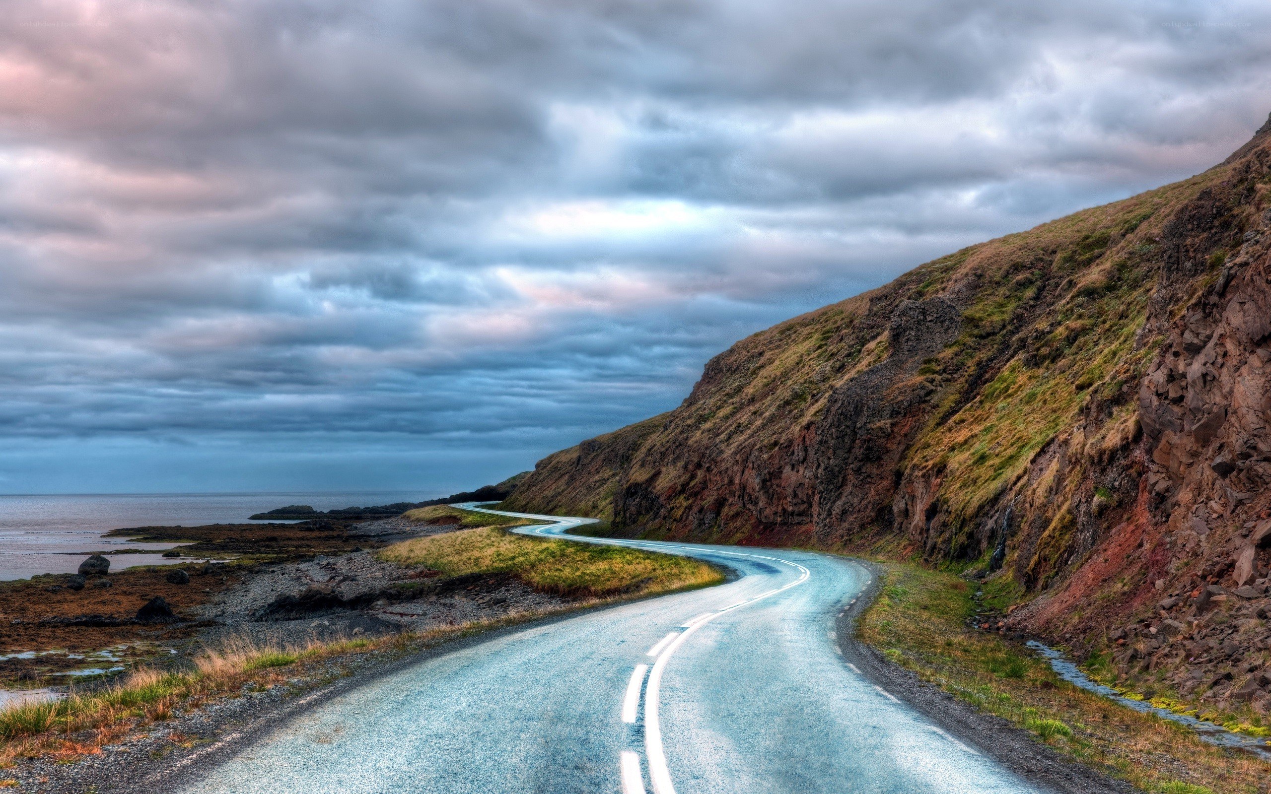 Winding coastal road at dusk
