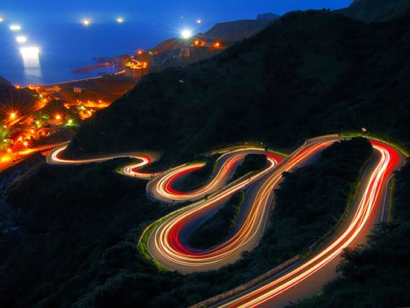 Winding coastal road at night