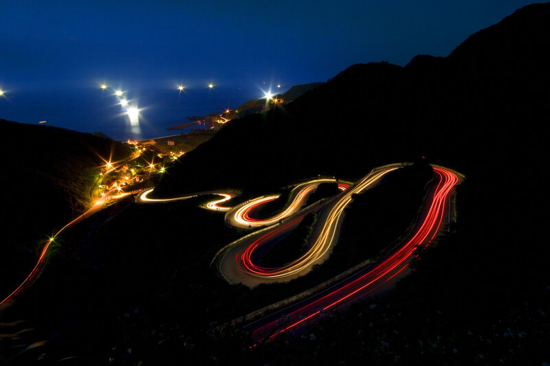 Winding coastal road at night