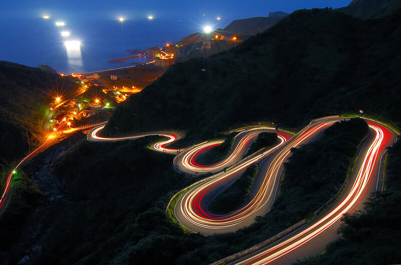 Winding coastal road at night