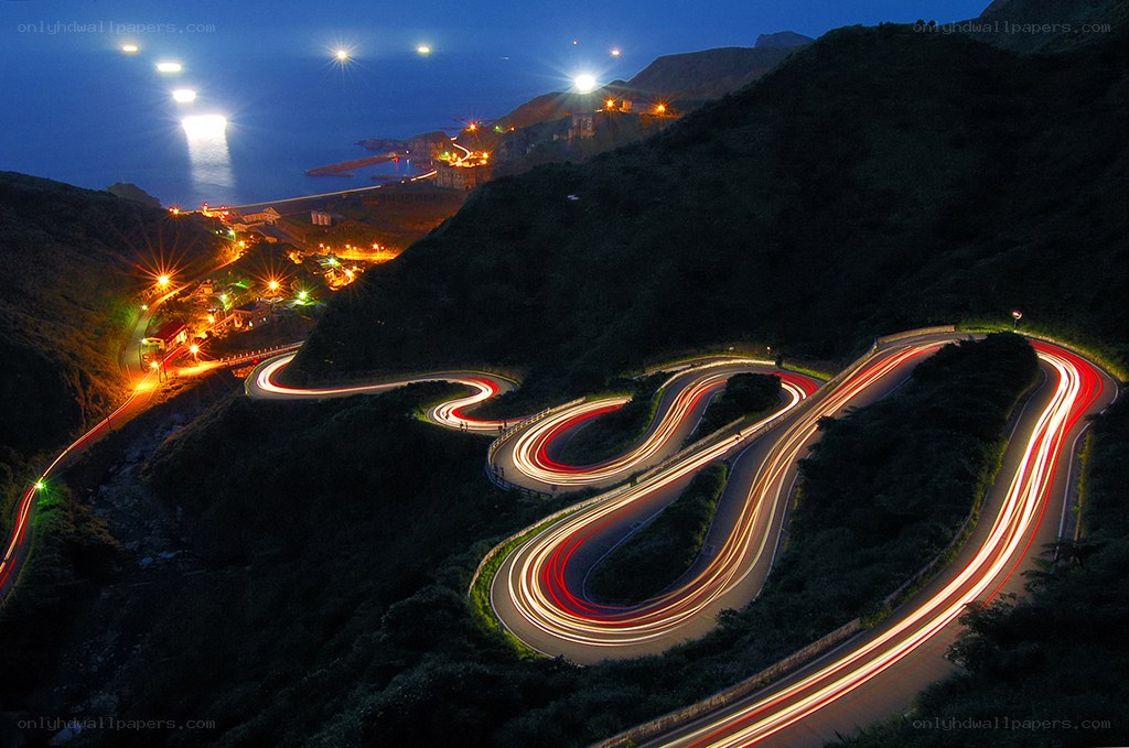 Winding coastal road at night