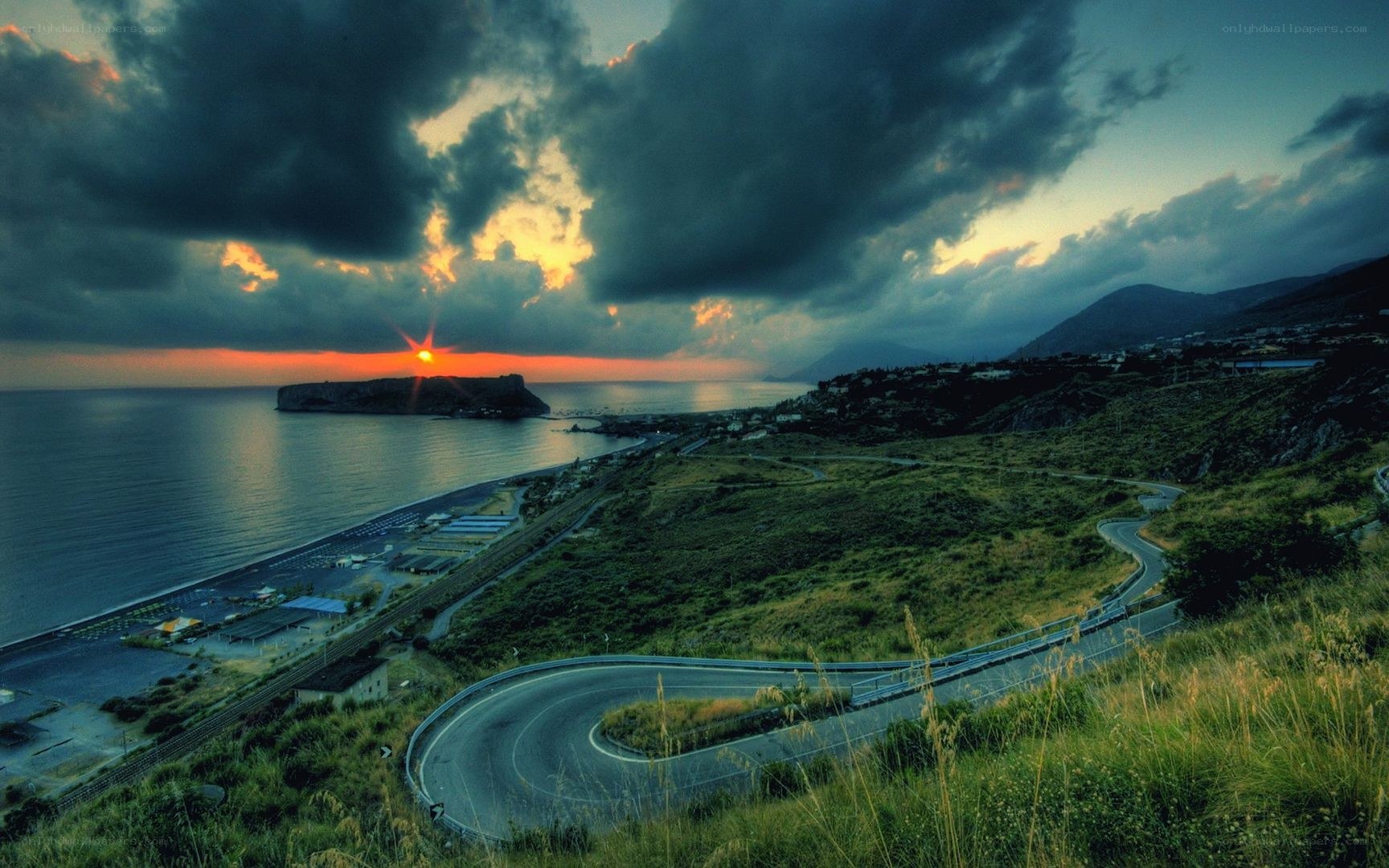 Winding coastal road at sunset