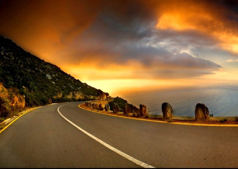 Winding coastal road at sunset