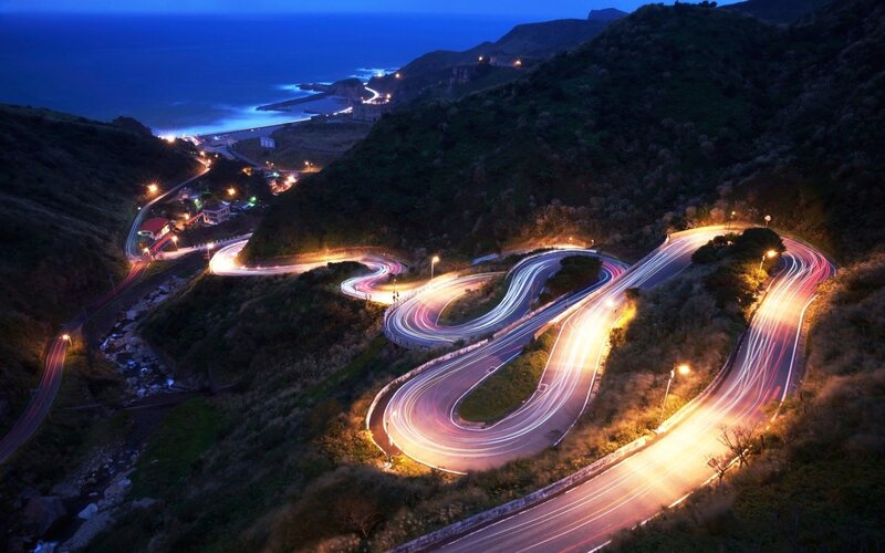 Winding Coastal Road — Blue, Dramatic, Night, Photograph, Mountain, Ocean, Lights, Curves