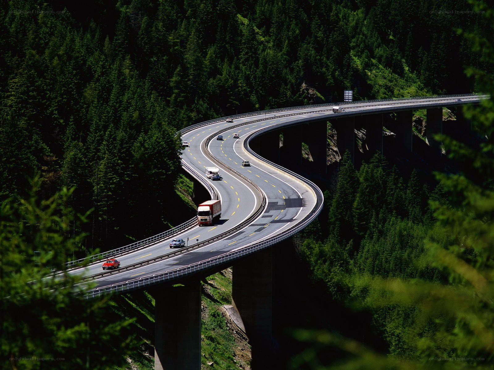 Winding highway through forested mountains