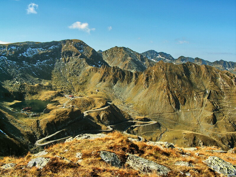 winding mountain road and lake