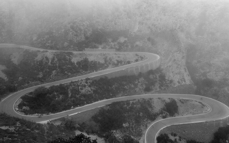 winding mountain road in fog