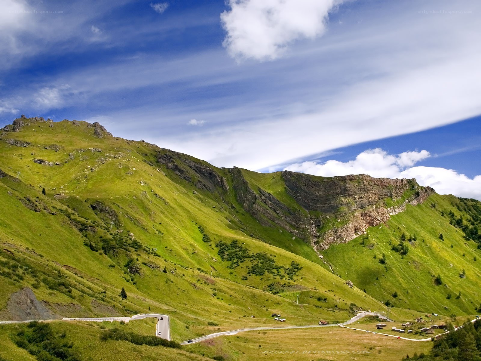Winding mountain road in green valley