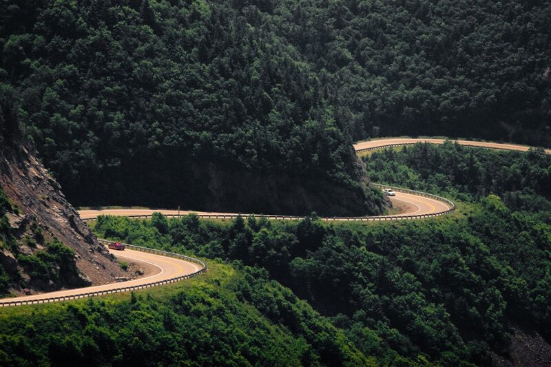Winding mountain road through forest