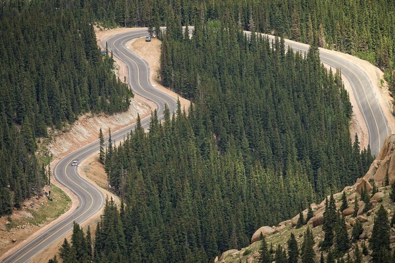 Winding mountain road through forest